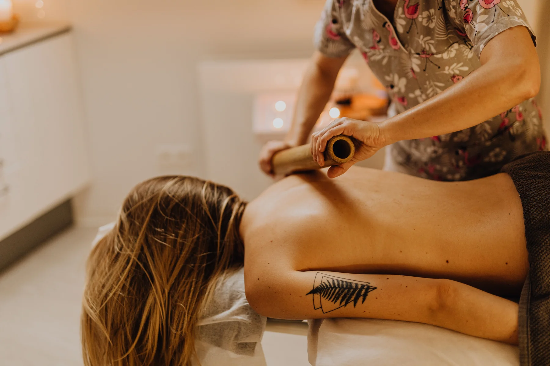 Professional bamboo massage technique in a bright spa environment